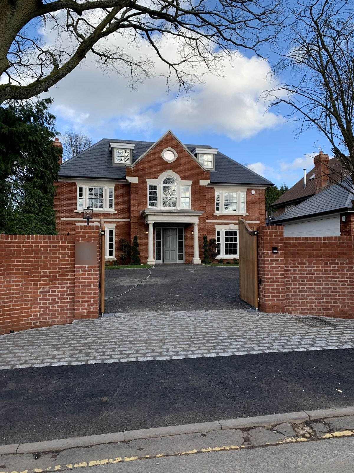 New build house behind its entrance gates